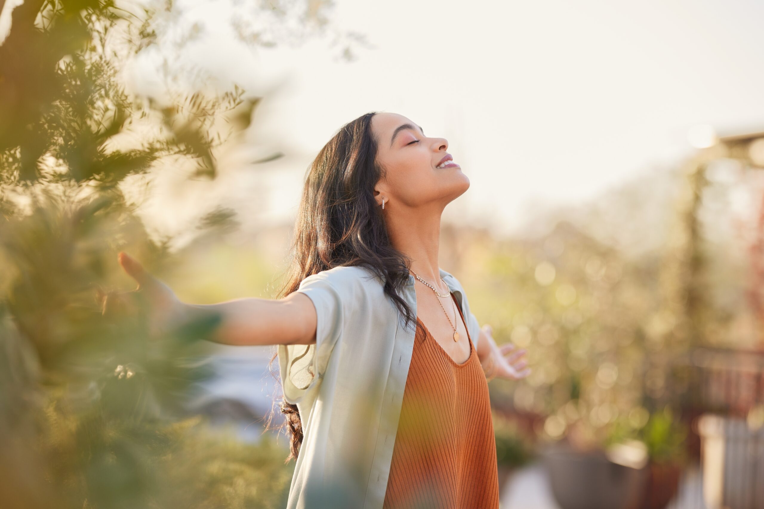Young,Latin,Woman,With,Arms,Outstretched,Breathing,In,Fresh,Air